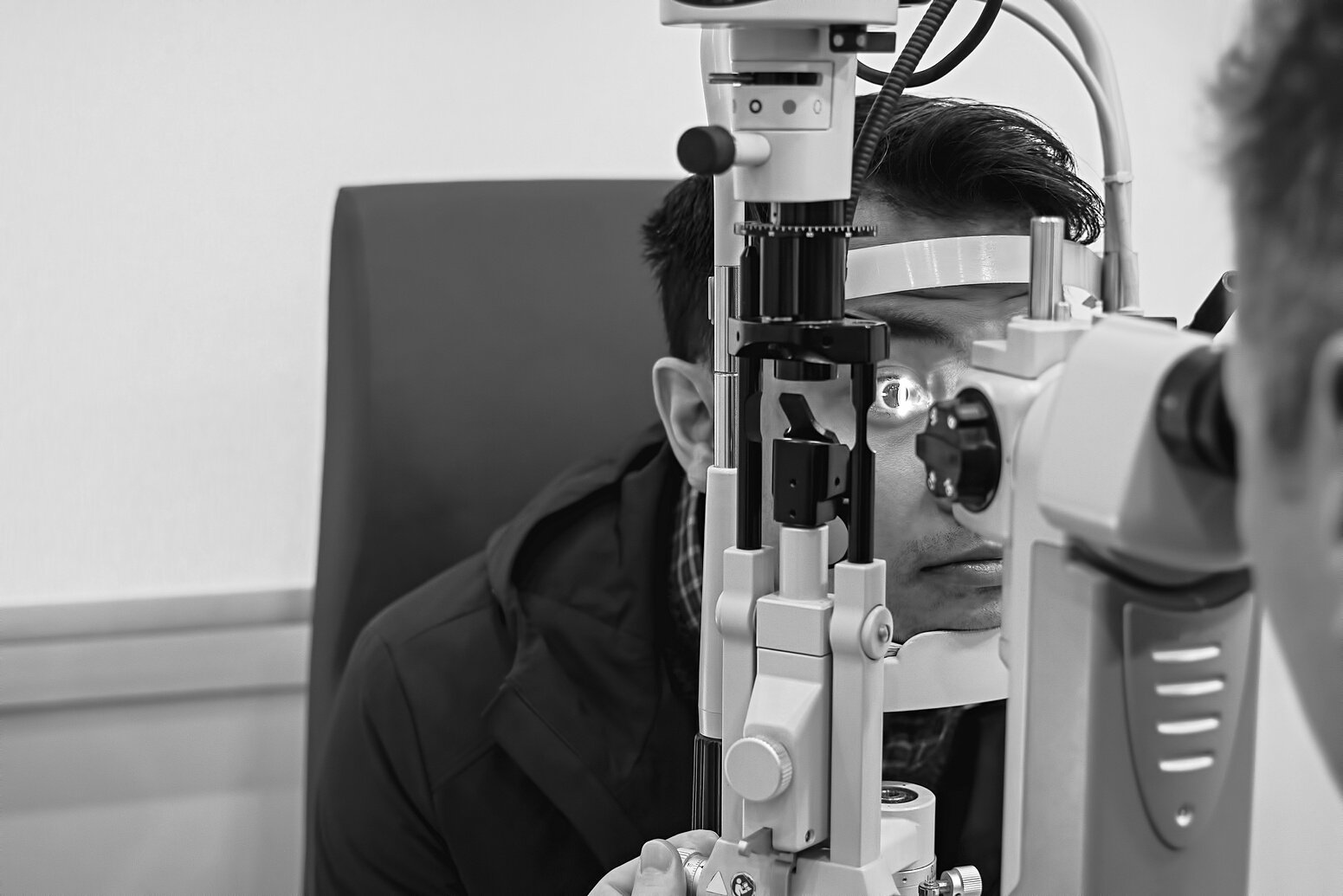 Eye doctor examining patient eyes after LASIK surgery